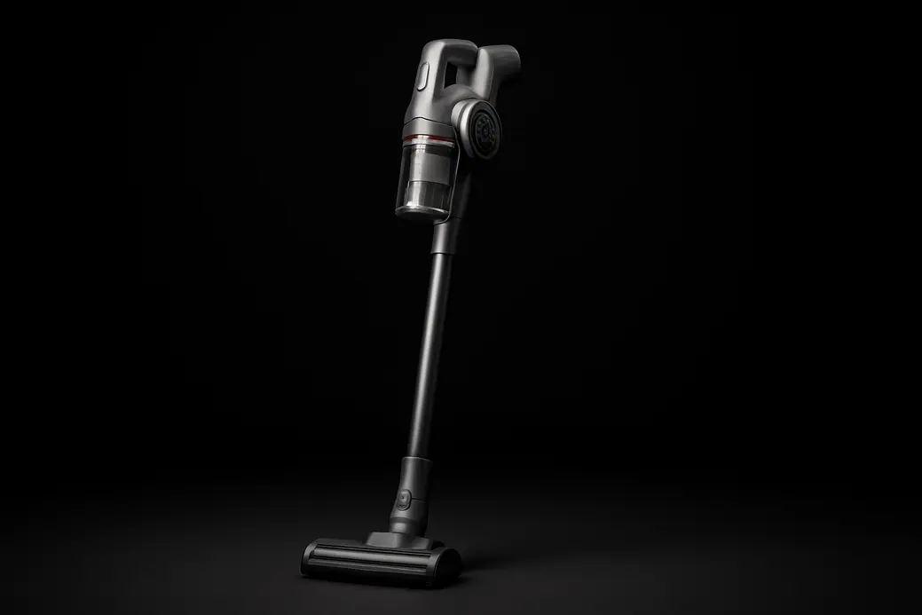 Clean product photo of a single cordless vacuum cleaner centered against a black background with soft, even spotlight illumination highlighting its complete form and sleek design